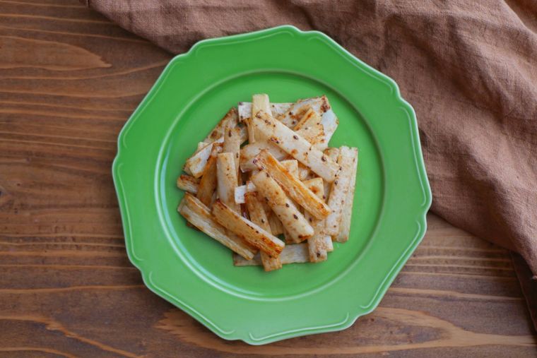 長芋の皮のバターしょうゆソテーが緑色の皿に盛られている