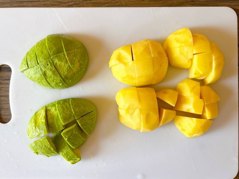 まな板におかれたカットしたアボカドとじゃがいも