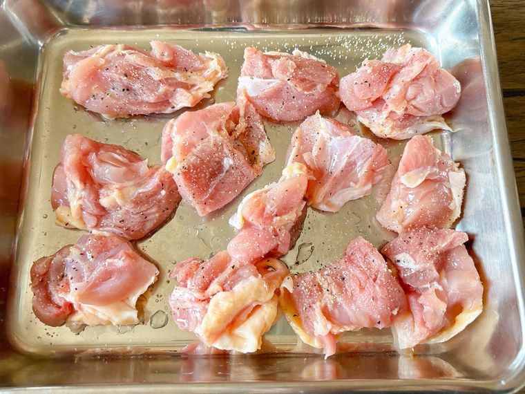 金属トレーにおかれたひと口大の鶏もも肉