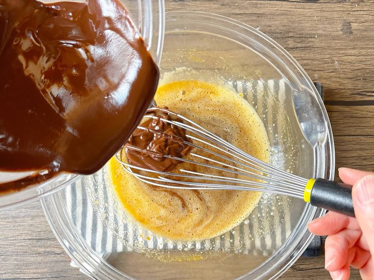 卵液の中に溶かしたチョコレートとバターを加える様子