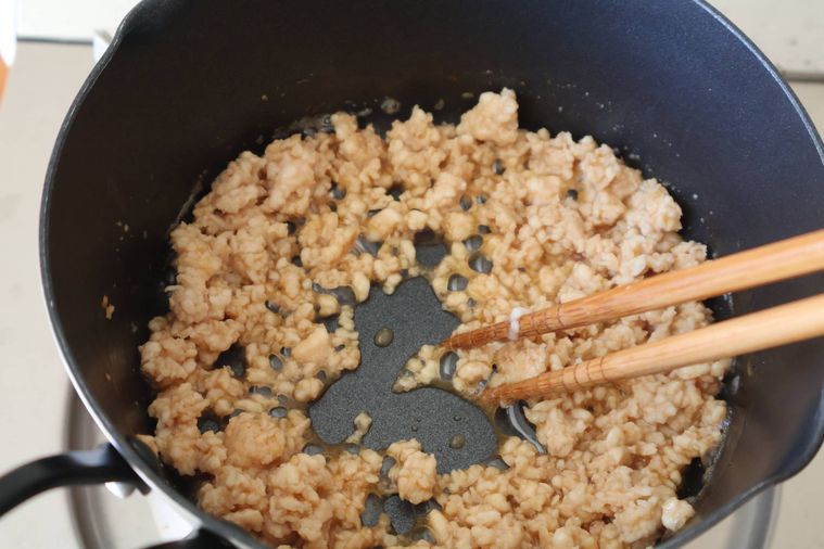 鶏そぼろを炒めている