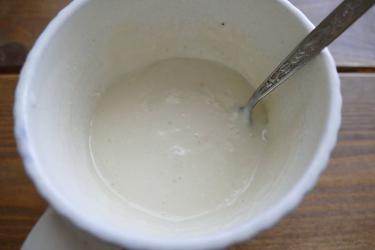 マグカップに材料を入れてスプーンで混ぜる様子