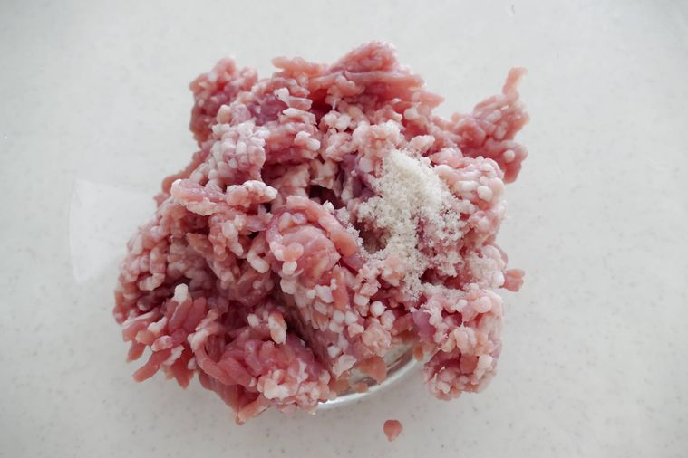 ボウルに豚ひき肉と塩を入れた様子